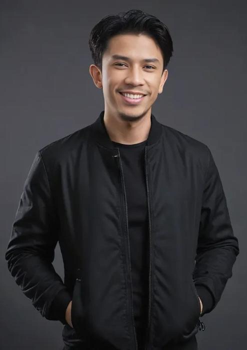Amir Zamzami, smiling, in a black bomber jacket